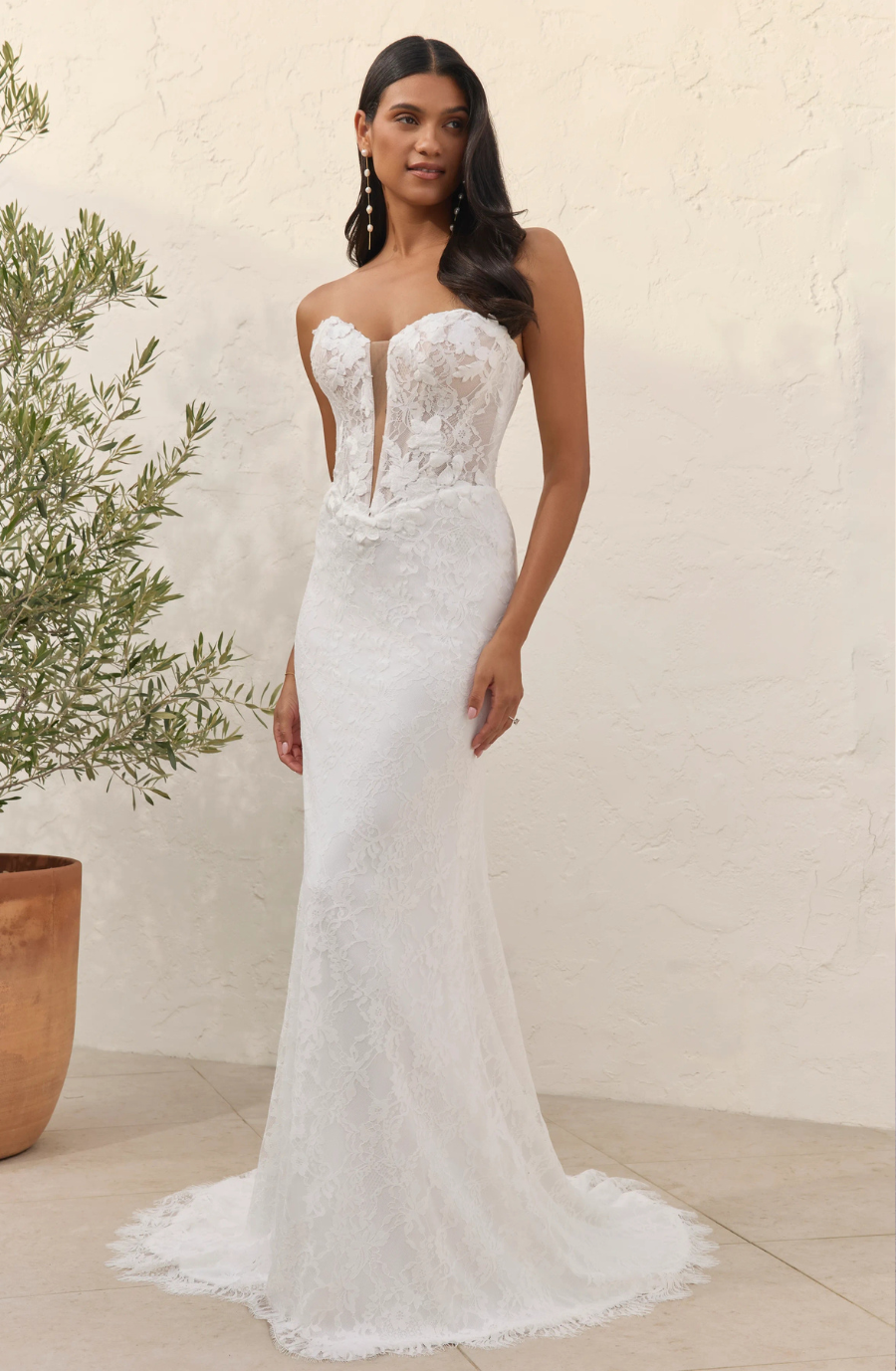 model is wearing a strapless fit and flare bridal dress