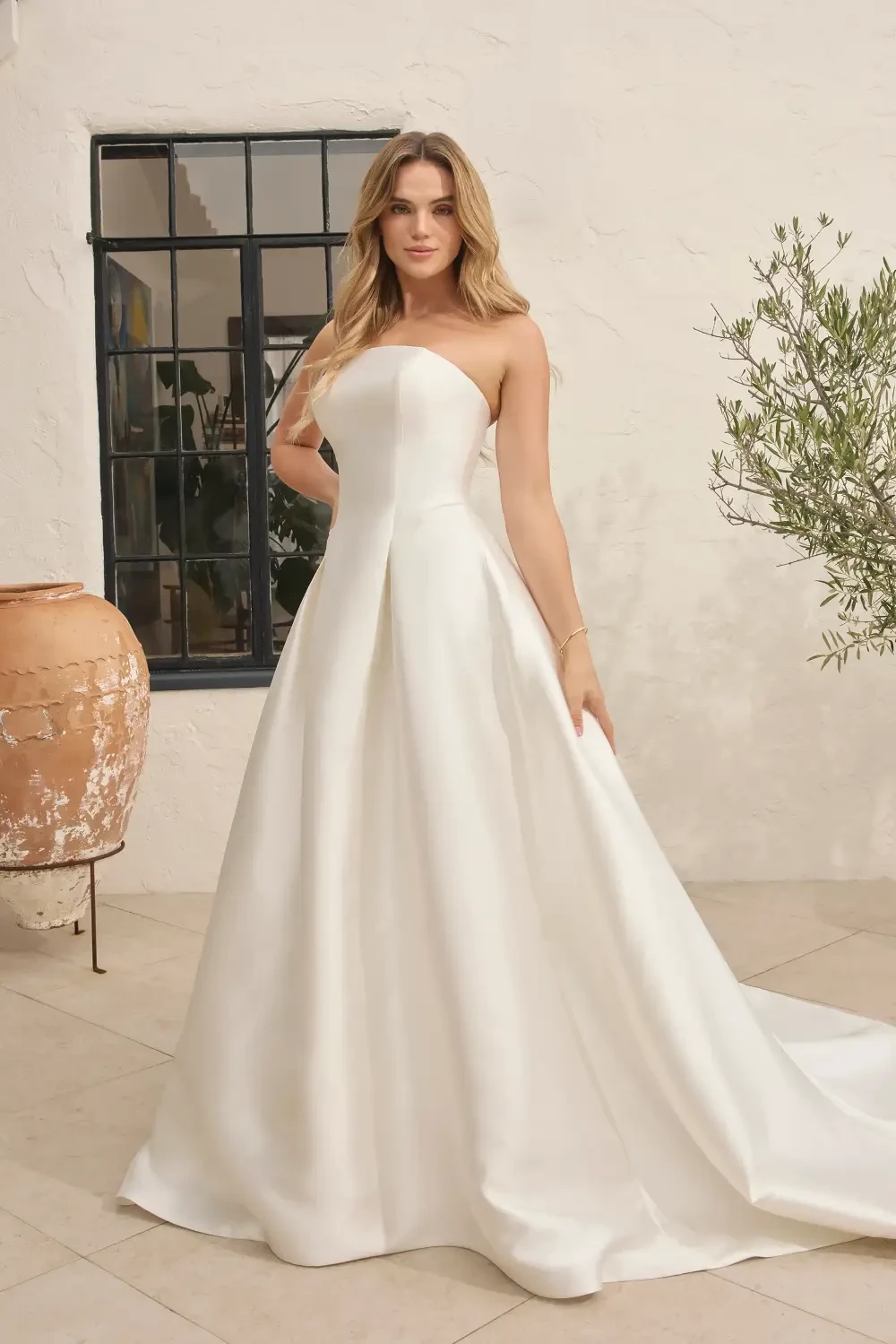 model is wearing a strapless ball gown