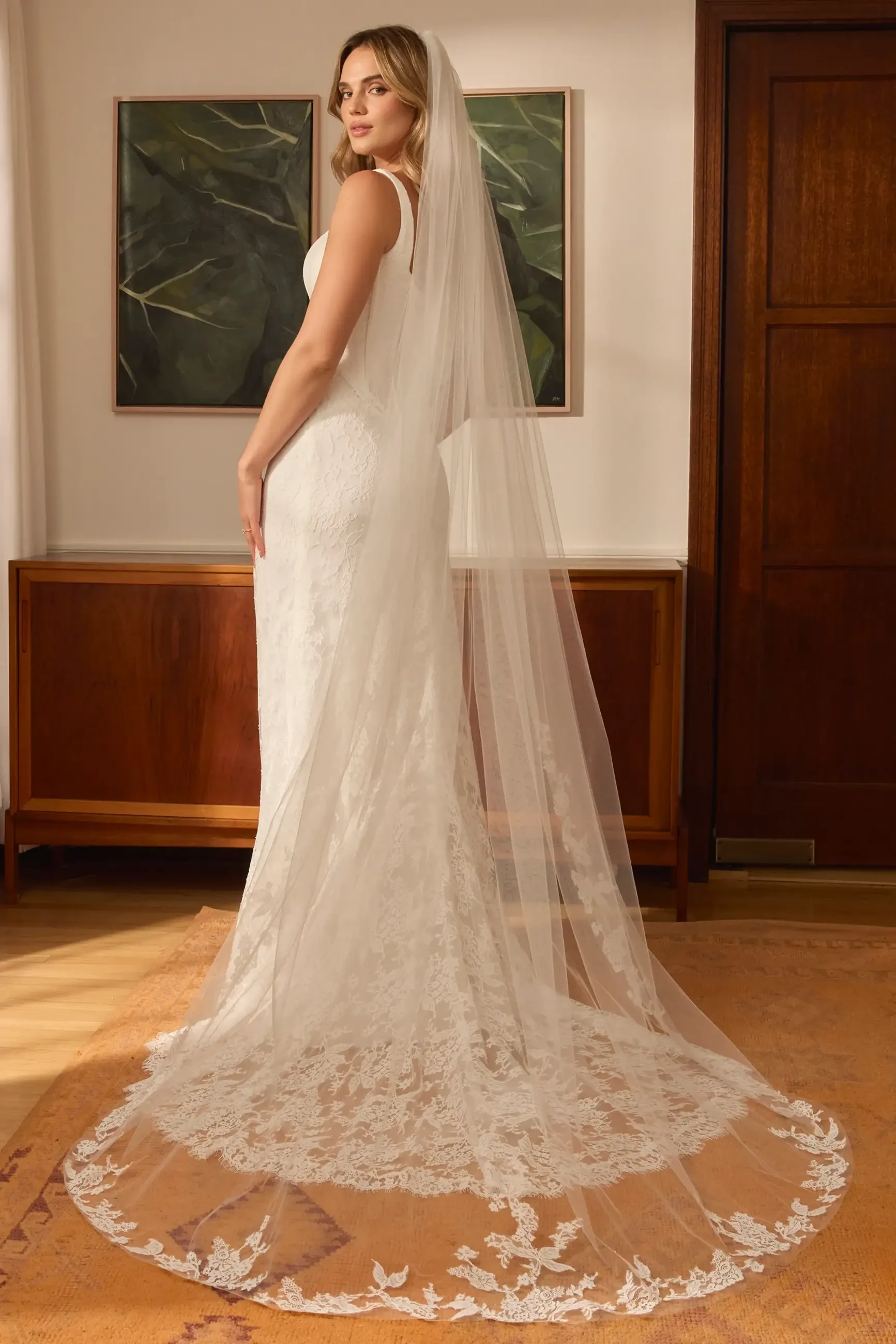 model is wearing a sleeveless fit and flare corset wedding gown