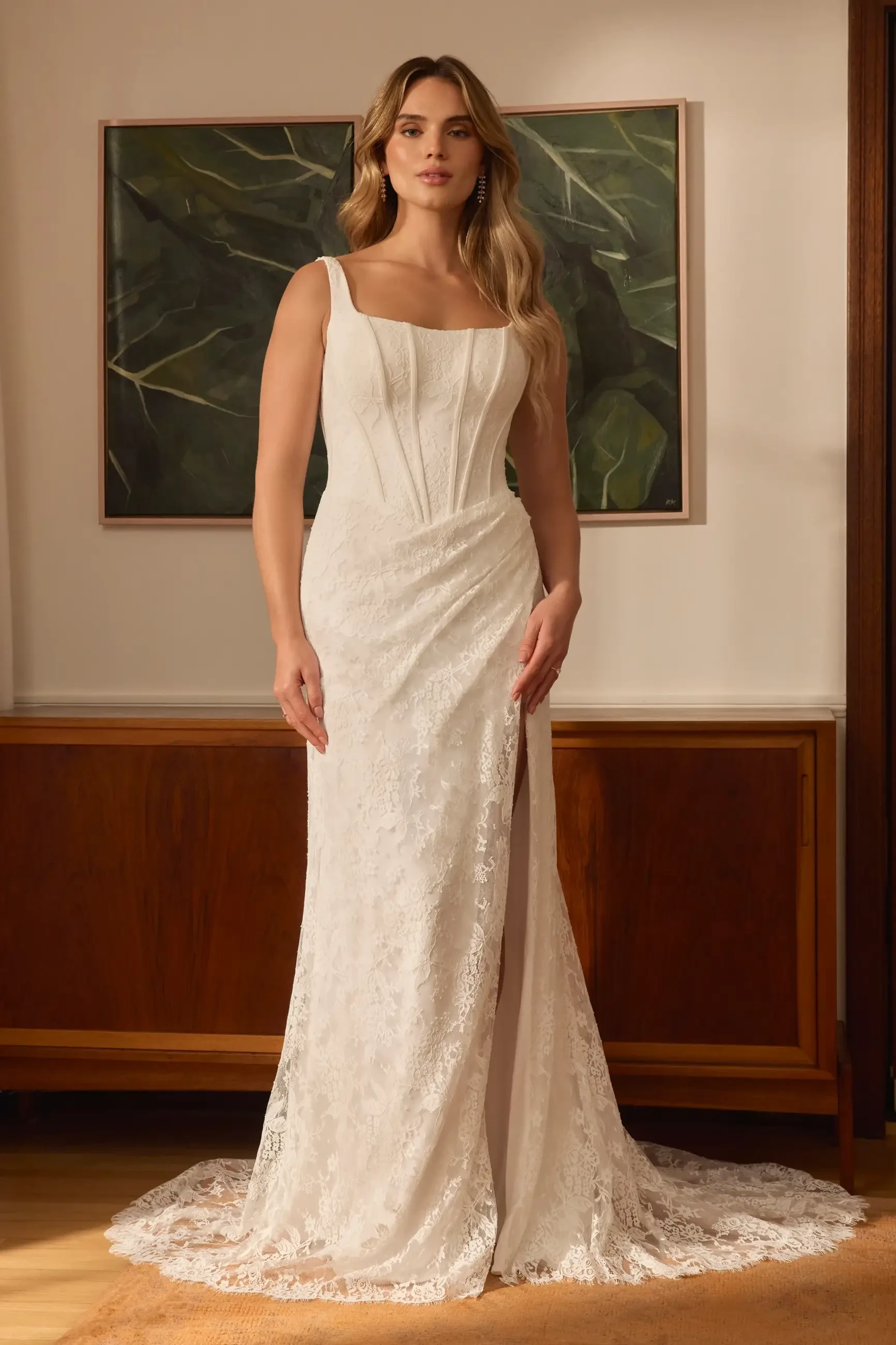 model is wearing a sleeveless fit and flare corset wedding gown