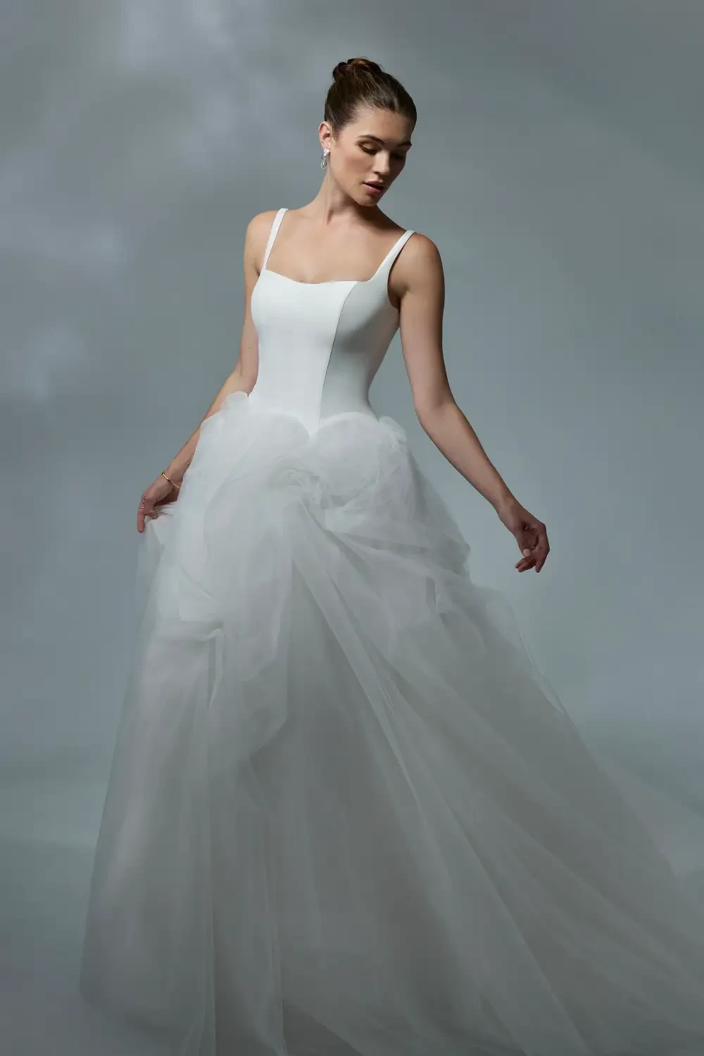 model is wearing a sleeveless a-line bridal gown