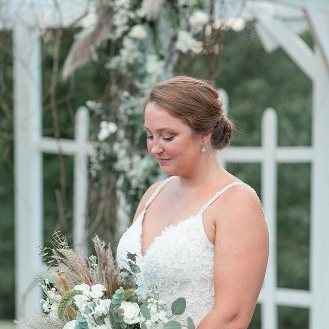 Model wearing a white gown with a flowers
