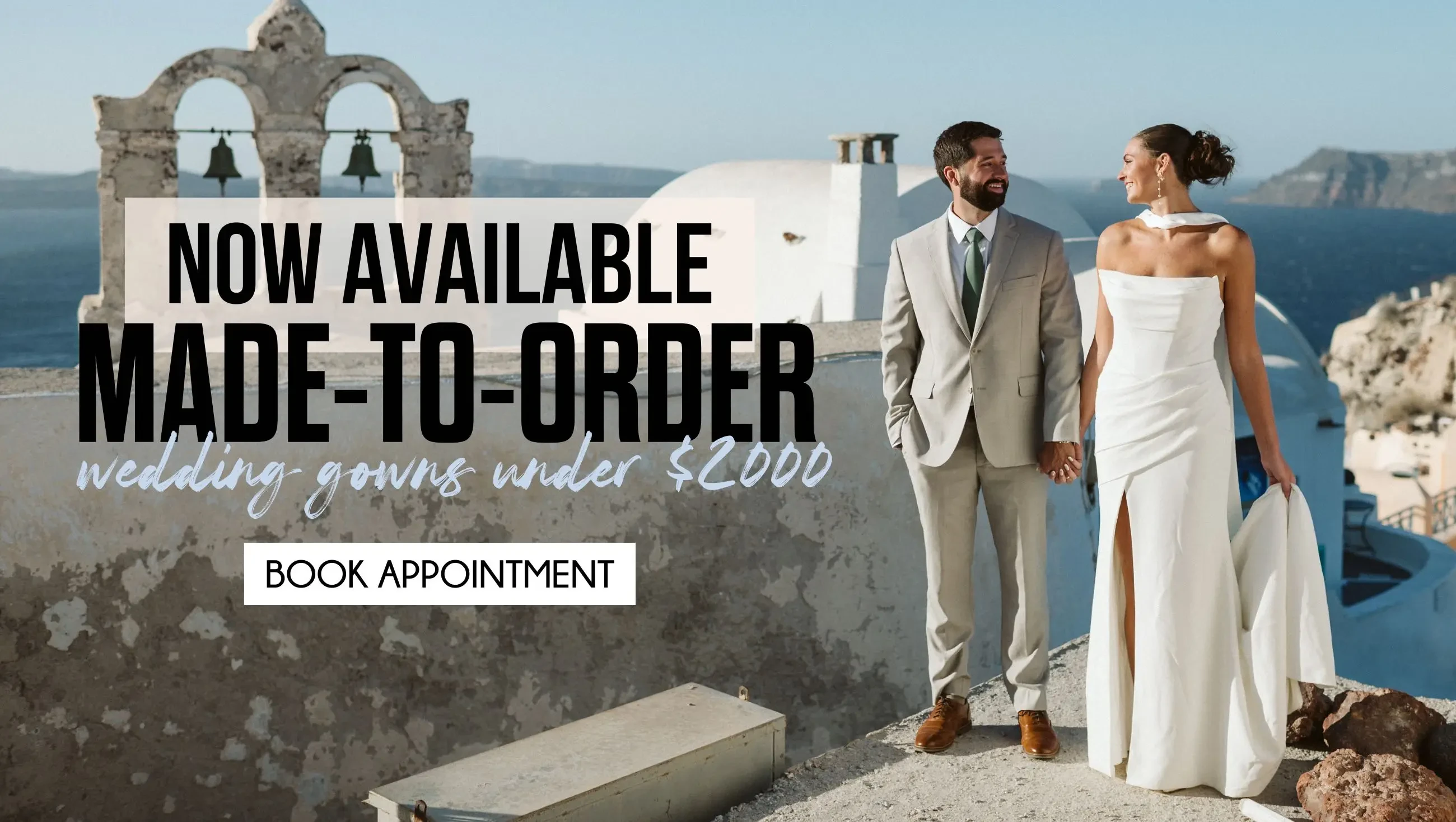 ONE OF A KIND WEDDING DRESSES SHOP IN STORE. BRIDE WEARS LONG SLEEVES LACE WEDDING DRESS WITH SHEER BODICE AND IS SEATED IN A VINTAGE CHAIR WITH WHITE CURTAINS BEHIND HER, LEANING ON HER HAND WHILE HER OTHER ARM IS OUTSTRETCHED ALONG HER CROSSED LEGS.